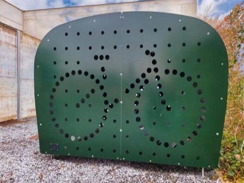 a green metal box with a circular design on it at Cozy Villa in Dalhem Ardennes with Private Garden in Dalhem