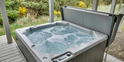 a bath tub sitting on a porch at Pacific Watch in Pacific City