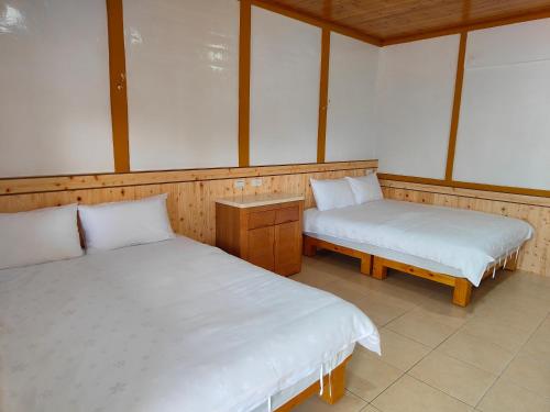 Postel nebo postele na pokoji v ubytování Chang Qing Ju Homestay