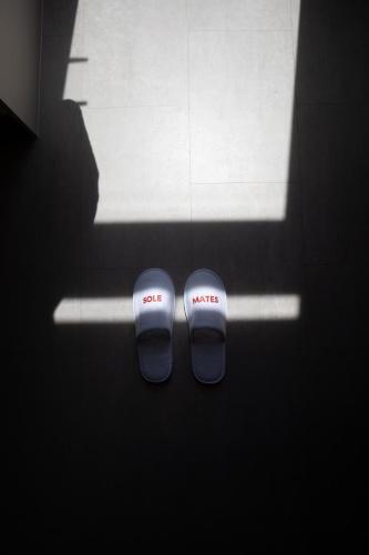 a pair of flip flops sitting in front of a window at Luxury Mirror Home in Byron Bay Hinterland in Binna Burra