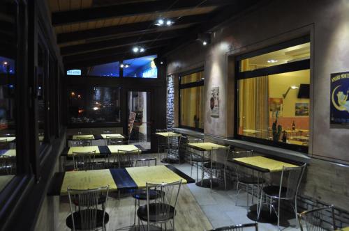 a restaurant with tables and chairs in a room at Hotel Paradise in Bruzolo