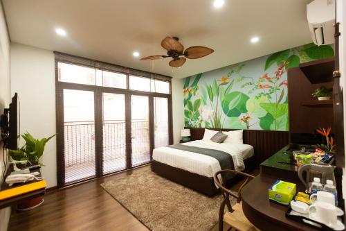 a bedroom with a bed and a ceiling fan at La Bonté Boutique Home Ho Chi Minh in Ho Chi Minh City