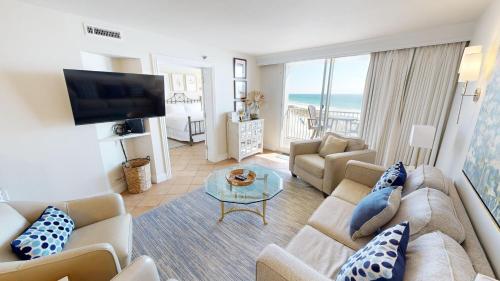 a living room with a couch and a tv at Destin on the Gulf 701 in Destin