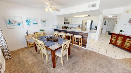 a kitchen and dining room with a table and chairs at Islander Beach Resort 6007 in Fort Walton Beach