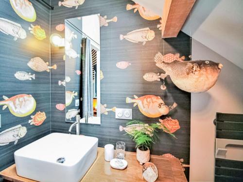 - une salle de bains avec du poisson peint au mur dans l'établissement Apartment in Saint Quirin near Scenic Pond, cleaning included, à Saint-Quirin