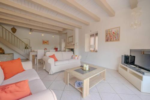 Il comprend un salon doté d'un mobilier blanc et d'une télévision. dans l'établissement The Villa of the Whispers of the South-West, à Villedoux