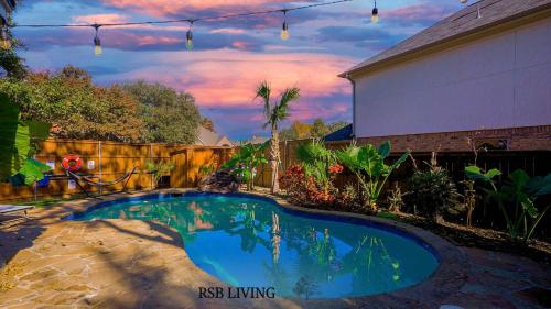 a swimming pool in the backyard of a house at Luxury Holiday Home 5BR Hot Tub, Pool & Beautiful Backyard in Grand Prairie