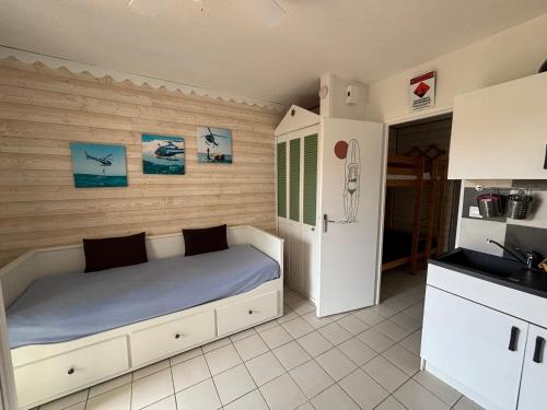 - une petite chambre avec un lit et un réfrigérateur dans l'établissement Appartement à deux pas de la mer, Biscarrosse Plage - 4 pers. - Terrasse et Parking inclus - FR-1-319-447, à Biscarrosse