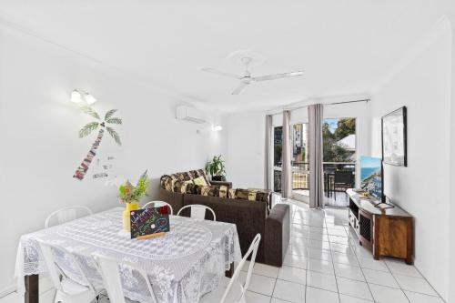 a living room with a table and a couch at Citysider Cairns Holiday Apartments in Cairns