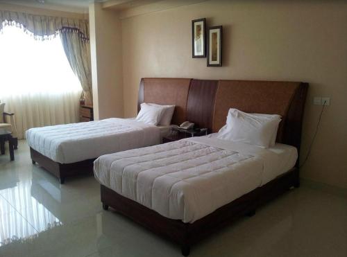 
Imperial Golf View Hotel tesisinde bir odada yatak veya yataklar
