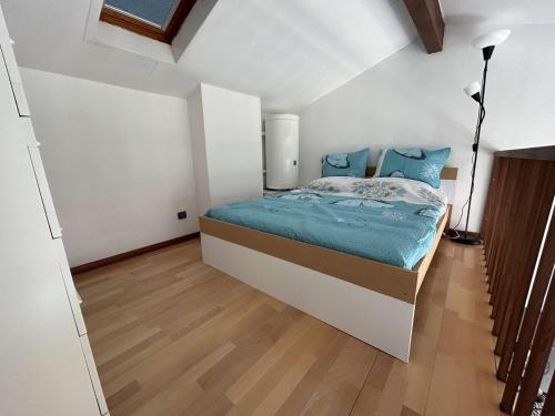 - une chambre avec un lit doté de draps bleus et d'oreillers bleus dans l'établissement Charmant T2 mezzanine avec vue mer et parking - FR-1-229D-161, à Fleury