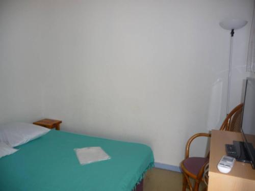 Cette petite chambre comprend un lit, un bureau et un ordinateur. dans l'établissement Maison climatisée avec terrasse et parking près de la plage - FR-1-782-77, au Barcarès