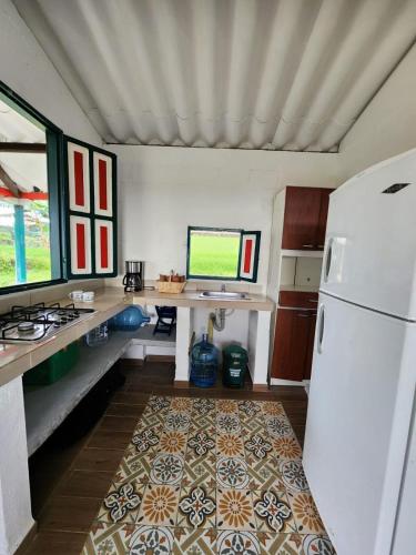 a kitchen with a desk and a refrigerator at Cabaña hospedaje Masinga in La India