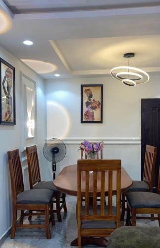a dining room with a table and chairs at Arek Condos Accra in Sotuom