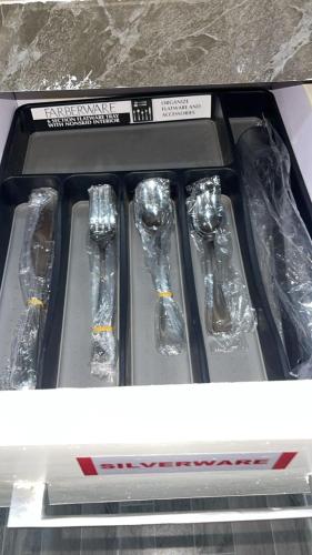 a drawer with four silver spoons in a box at Arek Condos Accra in Sotuom