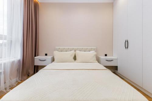 Postel nebo postele na pokoji v ubytování ЖК Respublica