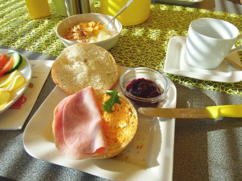 a plate of food with a sandwich on a table at Haus Margarethe in Mörbisch am See