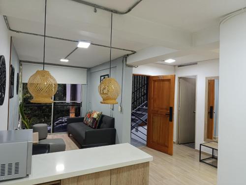 a living room with a couch and a table at Apartahotel Provenza 2 in Medellín