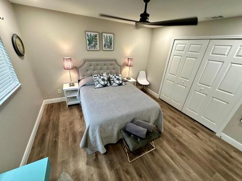 a bedroom with a bed and two white doors at Fort Myers Sunshine in Fort Myers