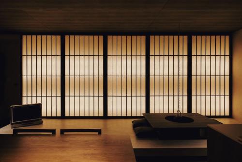 a living room with a couch and a large window at ONUJI stay in Busan