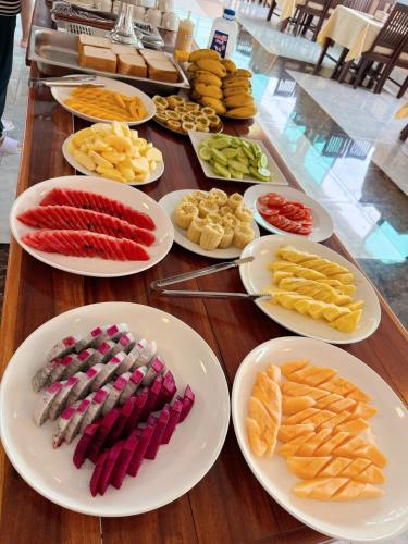 a table with plates of different types of food at Vangvieng Sisavang Hotel in Vang Vieng