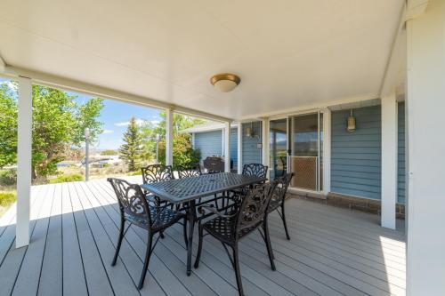 a patio with a table and chairs on a porch at Hilltop Heaven - 5 Star Comfort and Views in Panguitch