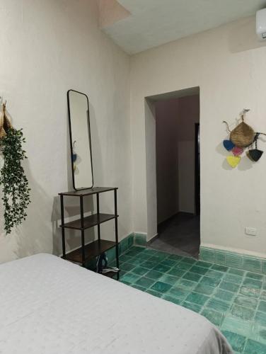 a bedroom with a bed and a mirror on the wall at Enjoy Mérida at Casa Cambas in Mérida