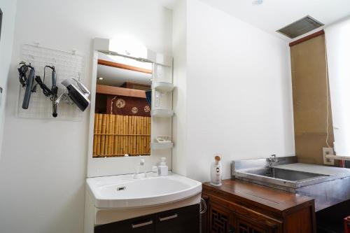 a bathroom with a sink and a mirror at Hotel HERMIT in Takamatsu