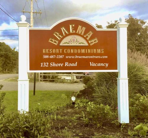 a sign for a resort compound with a sign for a road at The Braemar Condominium in North Truro