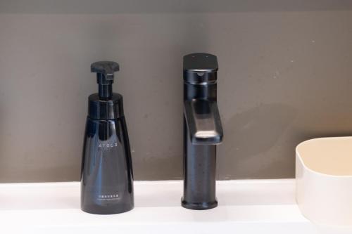 two bottles sitting next to each other on a counter at Atour Light Hotel Zhuhai Chimelong Tourist Resort Chimelong Station in Zhuhai