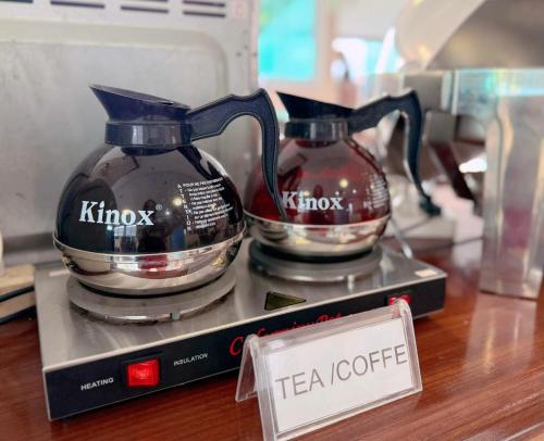 two tea pots sitting on a table with a tea certificate at Vangvieng Sisavang Hotel in Vang Vieng