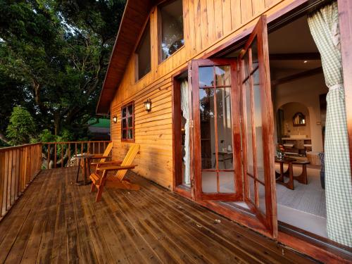 a large wooden deck with a sliding glass door at La Maison Sereine in Guangzhou