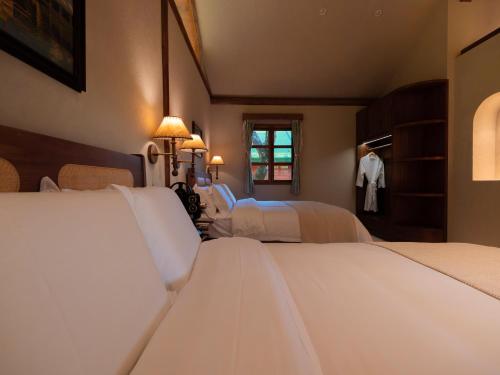 a bedroom with two beds and a closet at La Maison Sereine in Guangzhou