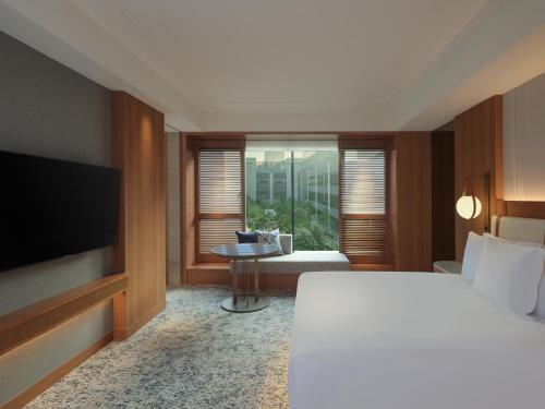 a hotel room with a bed and a television at InterContinental Yokohama Pier 8 by IHG in Yokohama