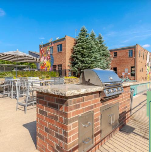 a brick oven with a grill on a patio at Luxury Apartment in Bricktown Riverwalk in Oklahoma City