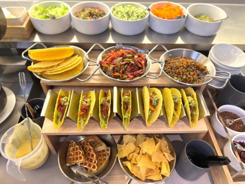 a buffet filled with different types of sandwiches and dips at Atour Light Hotel Guangzhou Panyu Hanxi Changlong-Free Midnight Snack&16 minutes drive to Conton Fair&Free Coffee Togo&Free Laundry and Drying services in Guangzhou