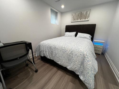 a bedroom with a bed and a desk in it at Cozy 2 Bedrooms Modern Basement Suite with Private entrance, Kitchen and parking in Mississauga