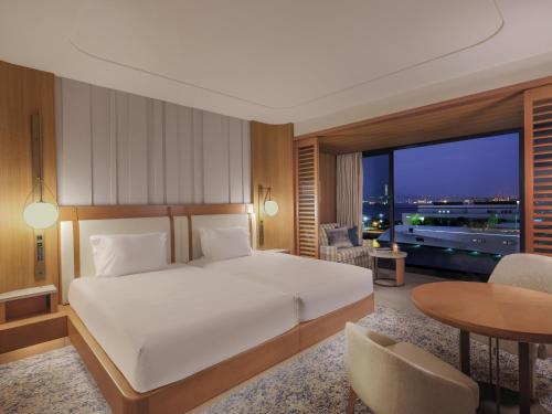 a bedroom with a bed and a desk and a table at InterContinental Yokohama Pier 8 by IHG in Yokohama