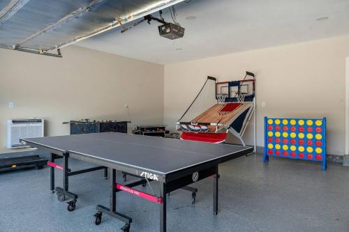 a ping pong table in a room with a ping pong racket at Play & Stay Dallas Home w Gym Gameroom WiFi in Dallas