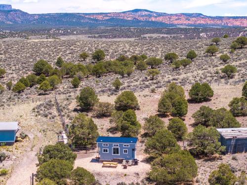 an aerial view of a blue house in a field at Hilltop Tiny Home in Panguitch