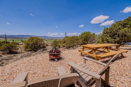 a picnic table and bench and a fire pit at Hilltop Tiny Home in Panguitch