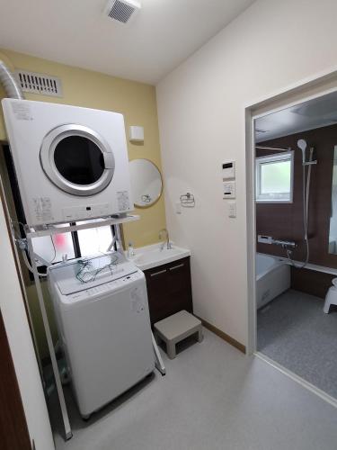 a bathroom with a sink and a washing machine at FunHome名古屋城II in Nagoya