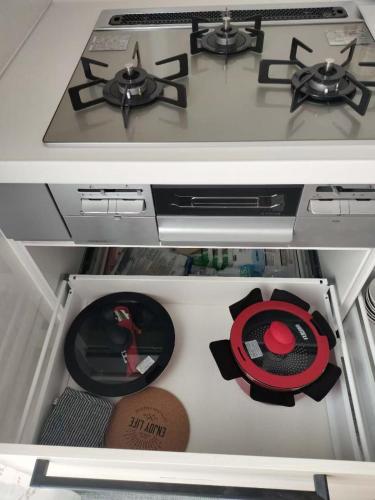 a stove top oven in a drawer of a refrigerator at FunHome名古屋城II in Nagoya