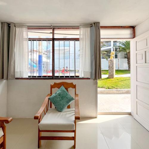 a room with a chair and a window at Direct Beach Access Apt & Speedy WiFi in Punta Hermosa