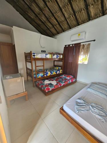 a room with two bunk beds in a room at Cabaña Sol y Mar 2 in Coveñas