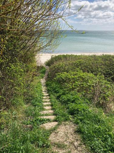a path leading to a beach with the ocean at Modern House In Second Row At Rude Strand in Odder