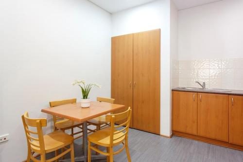 a dining room with a wooden table and chairs at Perth Central CBD convenience! in Perth