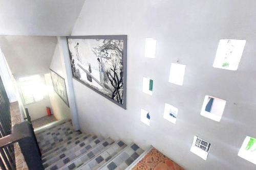 a hallway with a wall with pictures on it at Sukhum Suvarnabhumi Airport Guest House in Ban Klong Plad Kriang