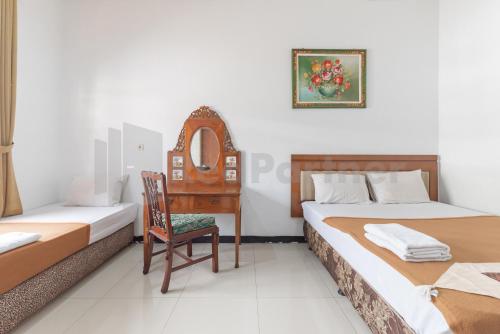 Postel nebo postele na pokoji v ubytování Wisma Green Maribaya Lembang