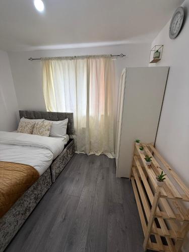 a bedroom with a large bed and a window at The Olive Villa in Manchester